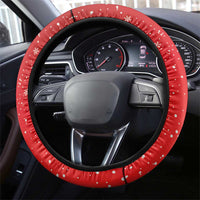 Red steering wheel cover with black edge and white snowflake dot pattern on the rim