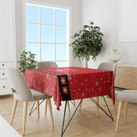 Red tablecloth with white snowflakes and Swiss cross accent band, draped on dining table