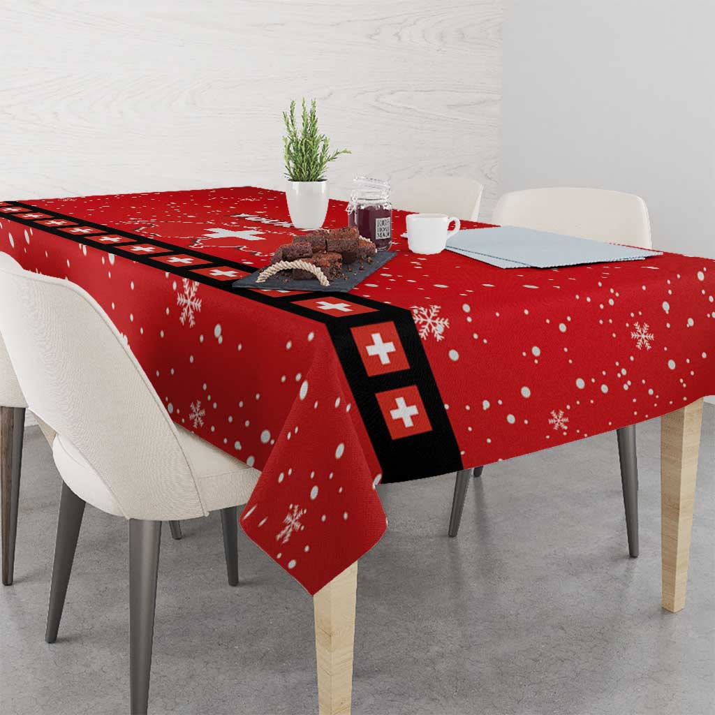 Red tablecloth with snowflake pattern and Swiss cross runner detail, corner drape on table