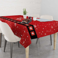 Red tablecloth with snowflake pattern and Swiss cross runner detail, corner drape on table