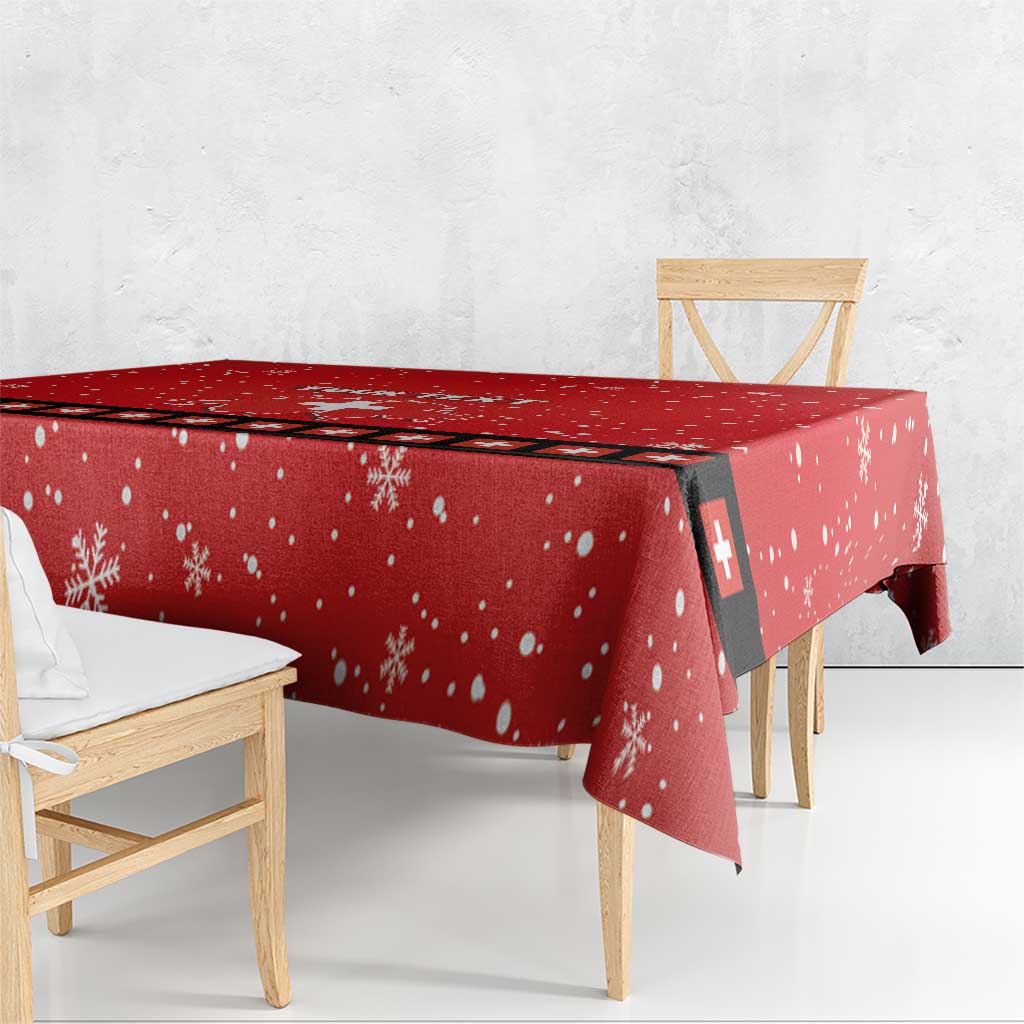Red snowflake tablecloth with Swiss cross stripe panel, draped over table edge