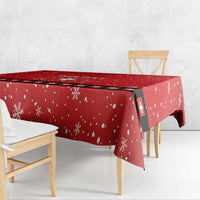 Red snowflake tablecloth with Swiss cross stripe panel, draped over table edge