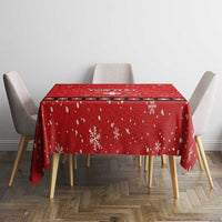 Red rectangular tablecloth with white snowflakes and Swiss cross detail, on dining table