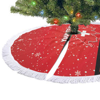 Red round tree skirt with white fringe, snowflake pattern and cross stripe on folded edge.