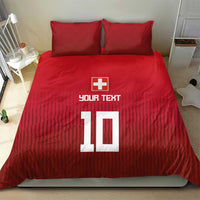 Red Swiss-style bedding set with duvet and two pillowcases, cross and '10' on striped pattern