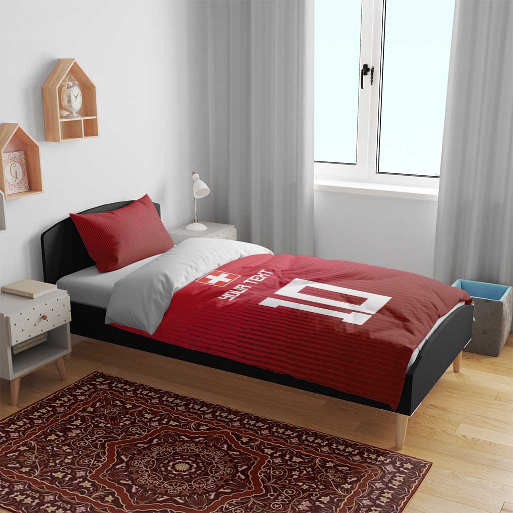 Red Swiss-style bedding set with duvet and pillowcases, cross emblem and '10' graphic