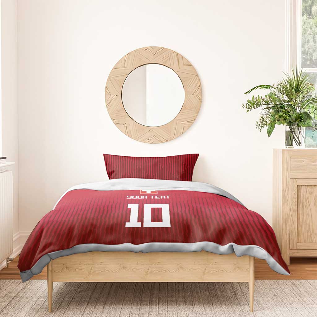 Red Swiss-style duvet and pillowcases with '10' graphic and cross emblem