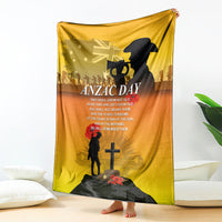 Yellow ANZAC Day blanket hanging with black soldier, rider silhouette and red poppy