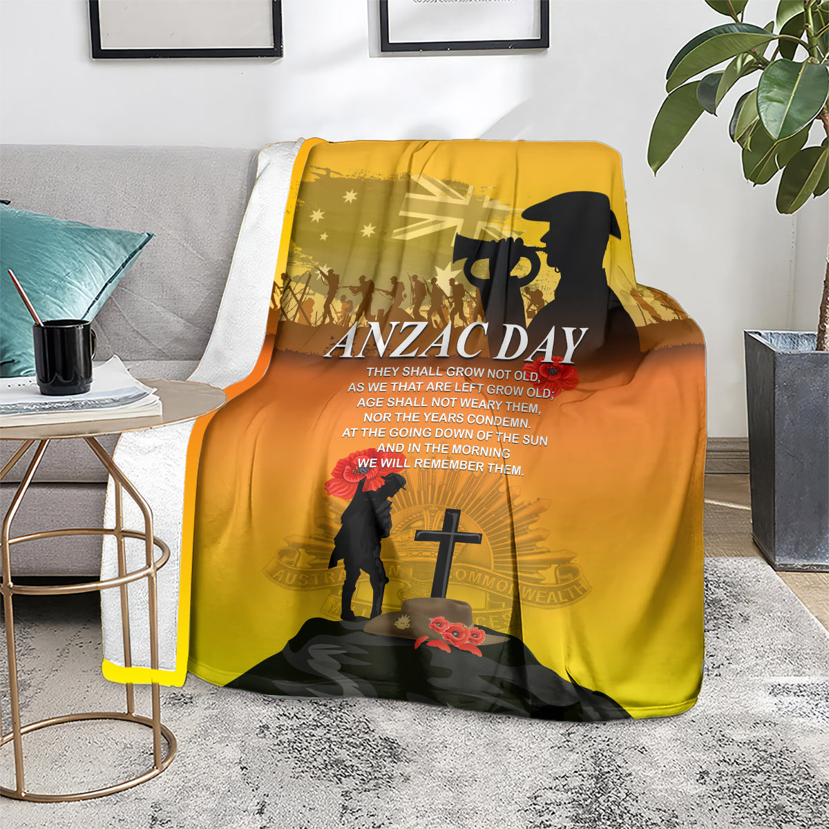 Yellow ANZAC Day blanket draped on floor with text, soldier silhouette and red poppies