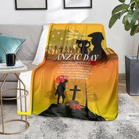 Yellow ANZAC Day blanket draped on floor with text, soldier silhouette and red poppies