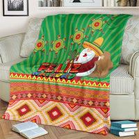 Green Feliz Navidad blanket with Santa and cactus, draped across loveseat