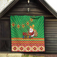 Green Feliz Navidad quilt hung indoors, with aztec geometric stripes and Santa artwork