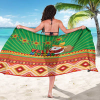 Green Christmas sarong draped on back, Feliz Navidad text and Santa graphic with hem pattern