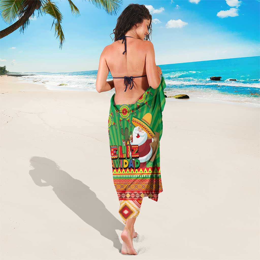 Green Christmas sarong worn at beach, Feliz Navidad print with striped Aztec hem and border