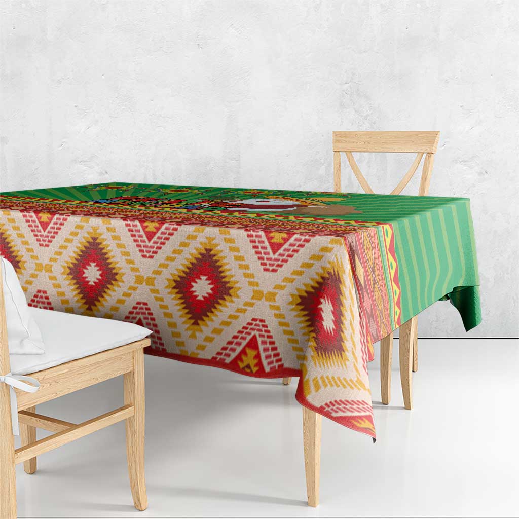 Green tablecloth with zigzag diamond pattern and multicolor southwestern border
