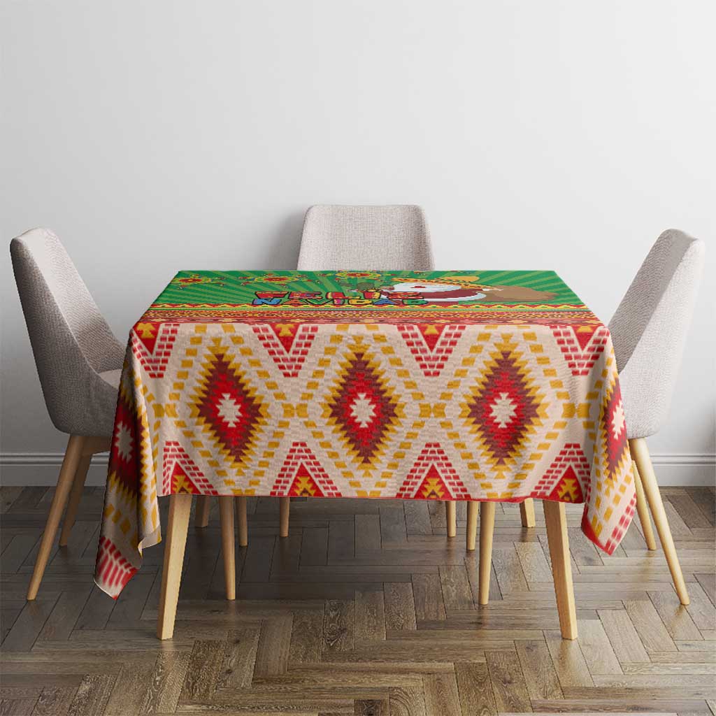 Green tablecloth with red, yellow, and white geometric diamond pattern