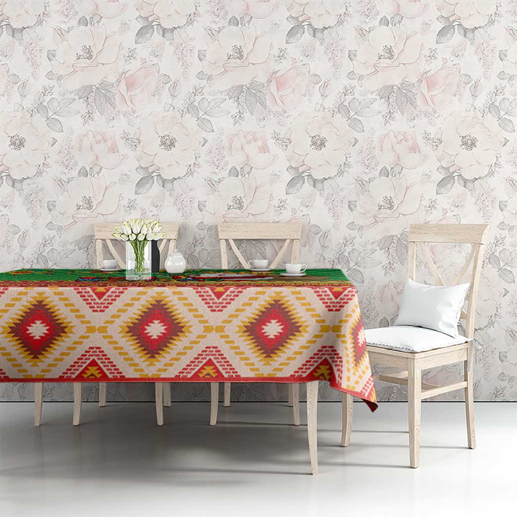 Green tablecloth with red and yellow diamond motifs and green striped edge