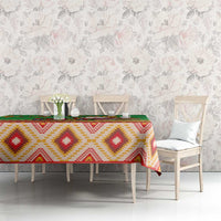 Green tablecloth with red and yellow diamond motifs and green striped edge