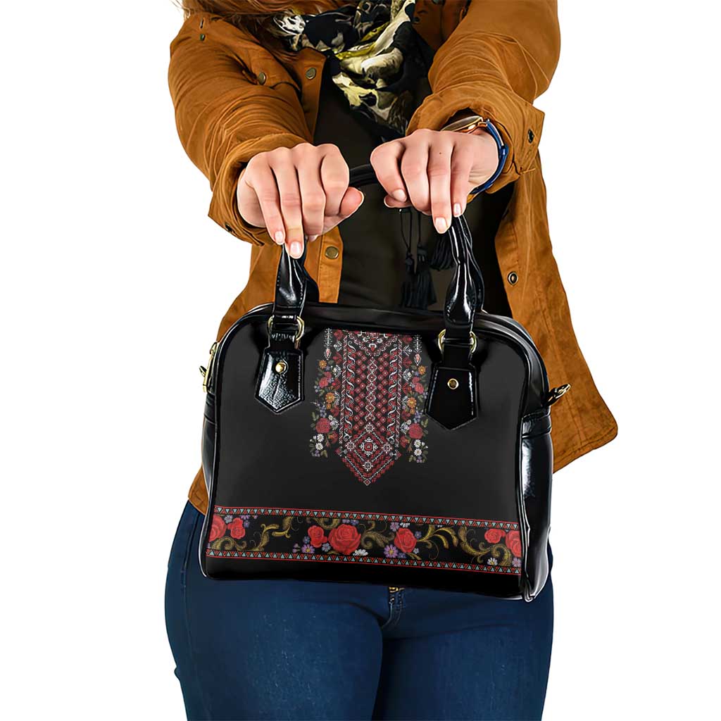 Black shoulder handbag with folk embroidery panel and decorative floral trim