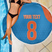 Round blue beach blanket with orange side panels, white fringe edge, 'YOUR TEXT' and 8