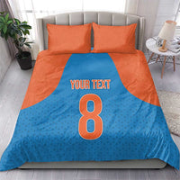 Blue and orange bedding set: duvet shows 'Your Text' and large 8, with 2 pillowcases