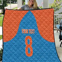 Personalized blue and orange quilt with a large number 8 and “YOUR TEXT”