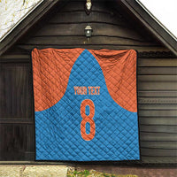 Personalized blue and orange quilt hanging under a porch with number 8 and “YOUR TEXT”