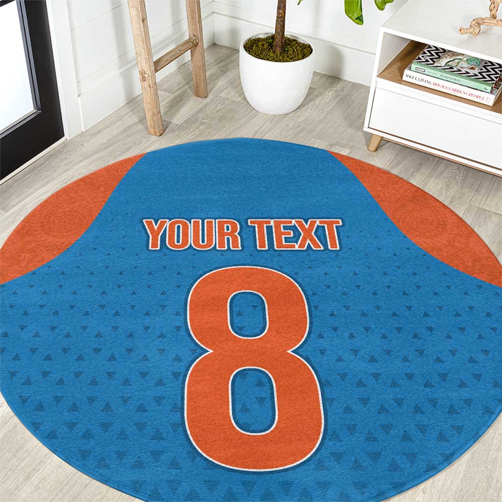 Round blue patterned carpet with orange border and large number 8