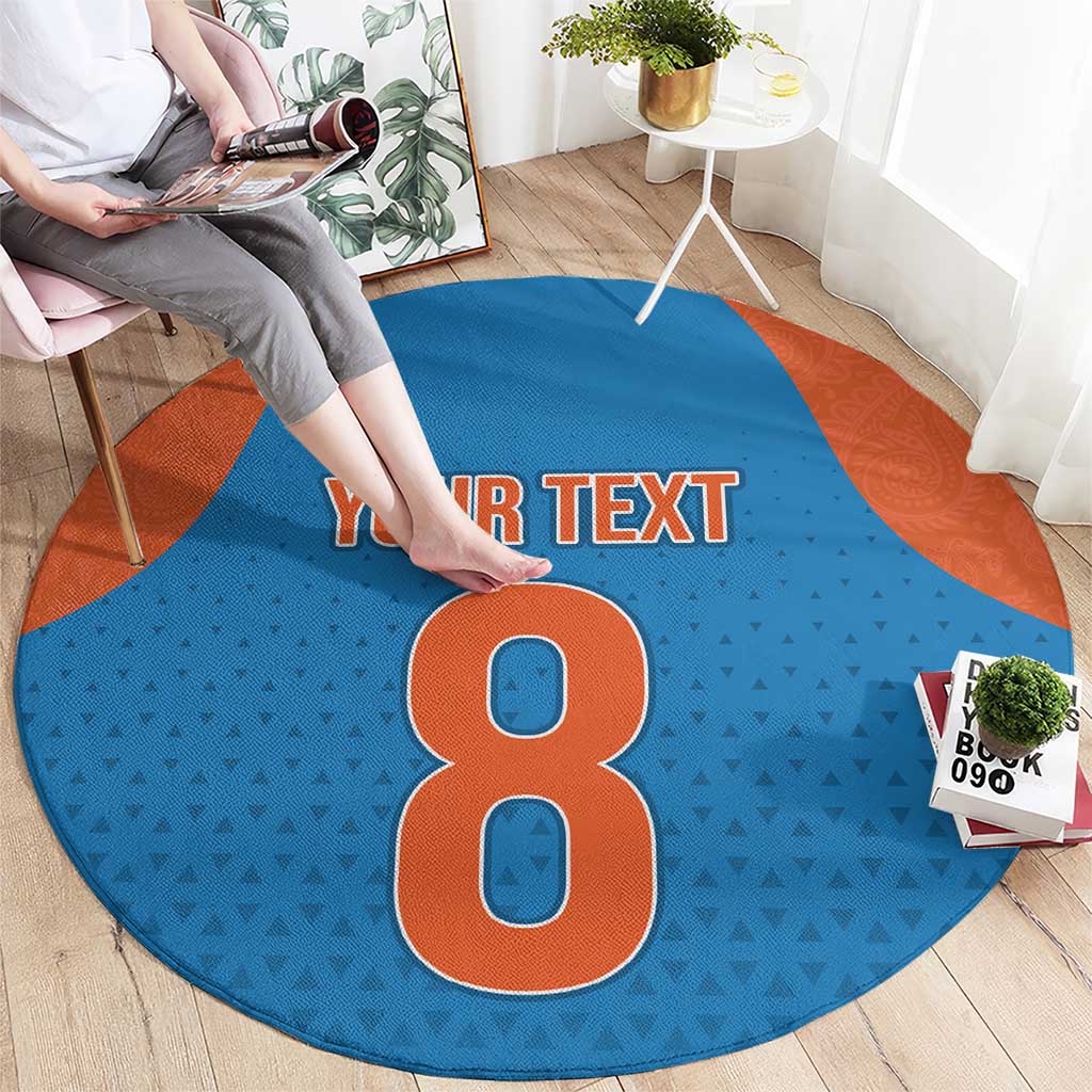 Round blue patterned carpet with orange border and large number 8