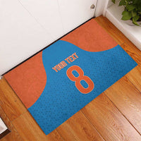 Custom blue rubber doormat with orange panels and 'YOUR TEXT' over large 8