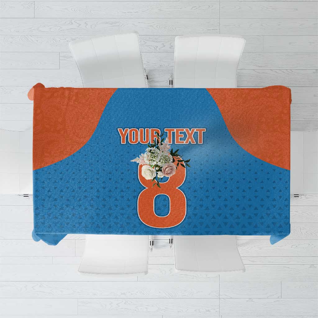Blue tablecloth featuring orange accents, "YOUR TEXT", and floral number design