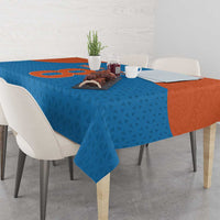 Blue tablecloth with dotted geometric pattern and orange panel, on a dining table