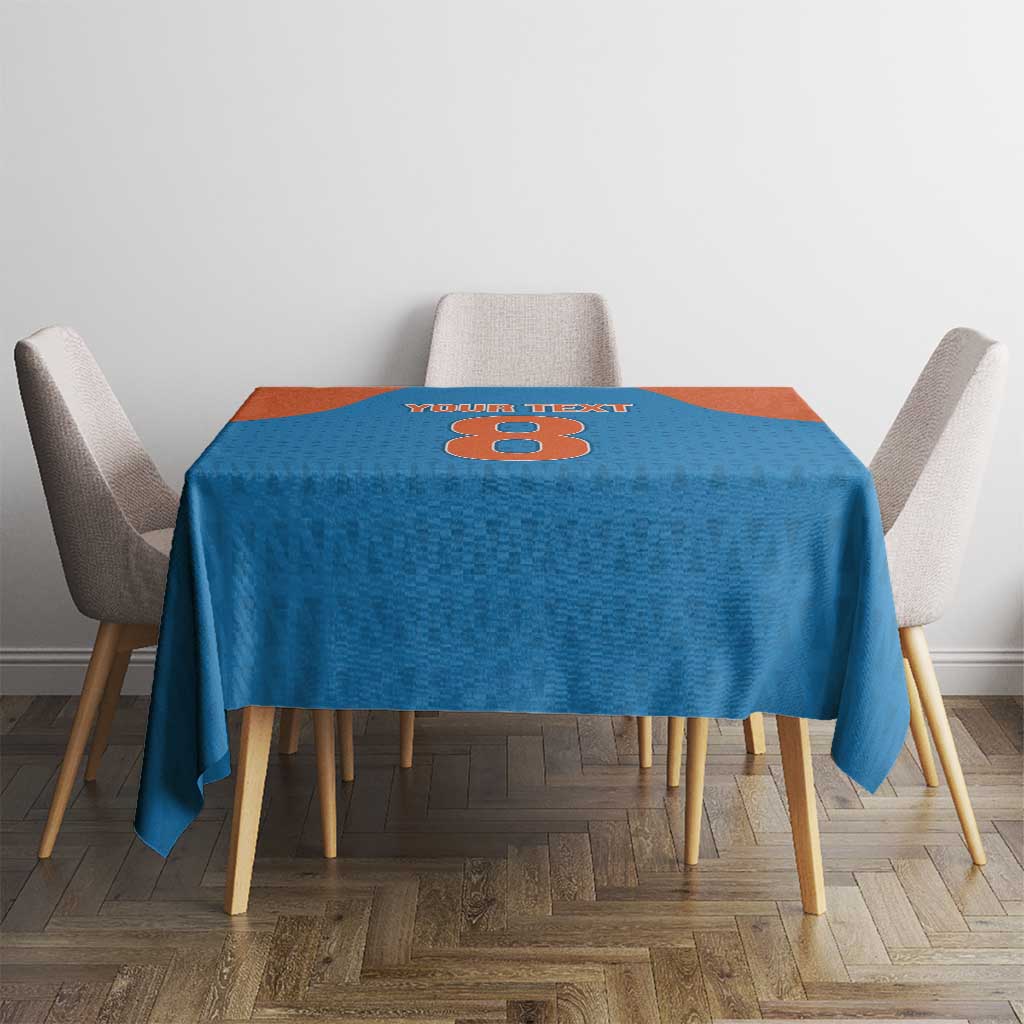 Blue tablecloth with orange center section and cricket-themed number design