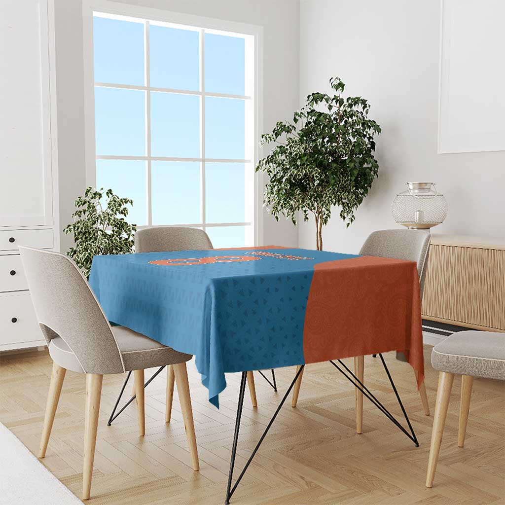 Blue tablecloth with orange side panel and patterned surface on a dining table