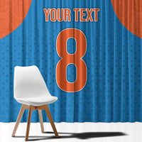 Close-up of blue window curtain with large number graphic and custom text at top
