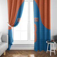 Two blue and rust orange window curtain panels framing a white door, with number graphic