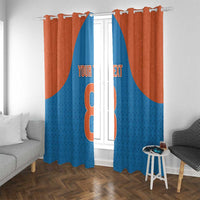 Window curtain panels in blue and rust orange with large number-style graphic in center