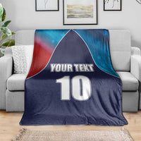 Personalized USA-style cricket blanket in navy blue with flag accents, “YOUR TEXT” and number 10 on sofa