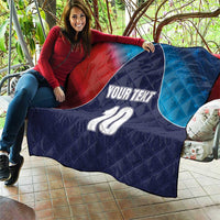 Quilted cricket quilt draped over couch with navy, red, blue flag-style panels and 10