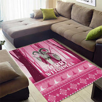 Pink Christmas area rug with Merry Christmas wording, witch illustration, and knit-style motifs