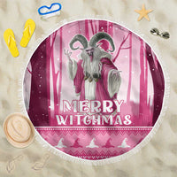 Pink round beach blanket with fringed edge, gray witch and “Merry Witchmas” text.