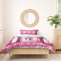 Pink “Merry Witchmas” witch bedding set on a wooden bed with coordinating duvet borders