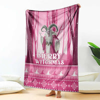 Pink Christmas witch blanket with 'Merry Witchmas' text and silhouettes, hanging on floor