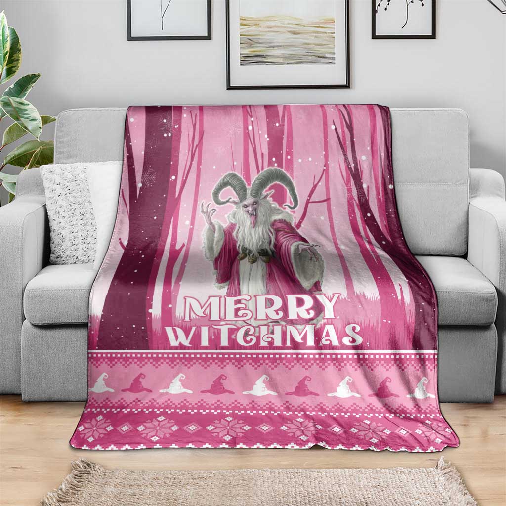 Pink Christmas witch blanket with large witch figure and 'Merry Witchmas' text, on sofa
