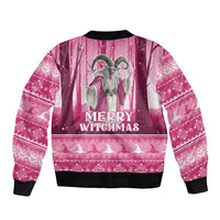 Unisex pink bomber jacket back shows witch graphic and 'Merry Witchmas' text, black rib cuffs/hem.