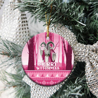 Pink round ceramic witch ornament hanging on a tree with “Merry Witchmas” print