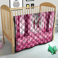 Pink quilt on crib mattress with gray witch figure and “Merry Witchmas”