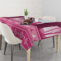 Pink Christmas tablecloth with reindeer, ornaments, and striped witch design