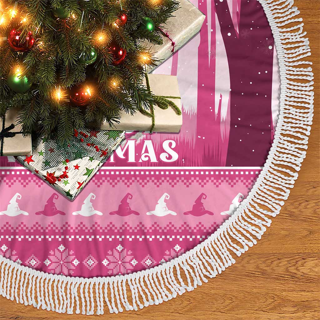 Pink round tree skirt with white fringe, festive pattern and witch silhouettes at edge