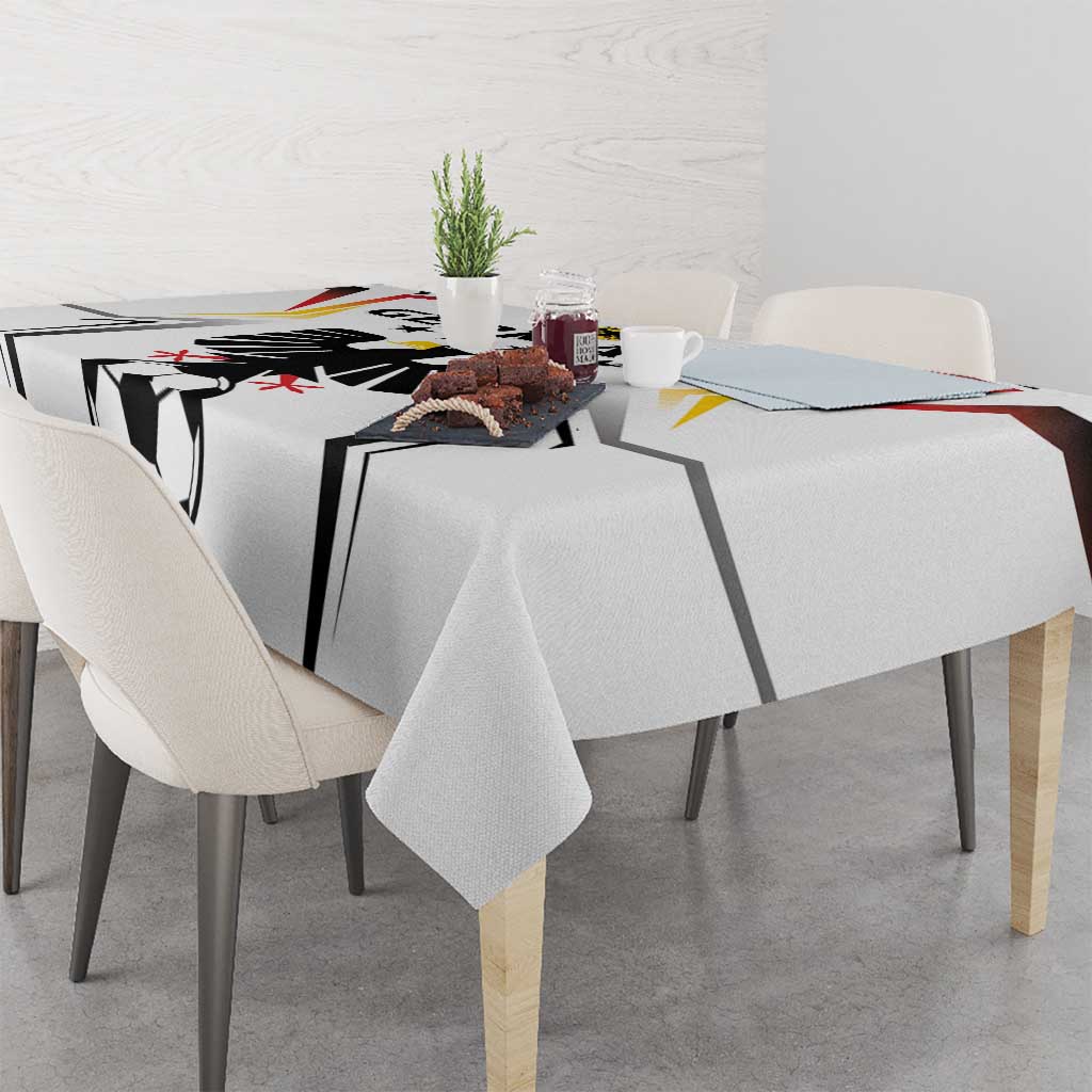 White football tablecloth with black soccer ball panel design, chairs and tabletop visible